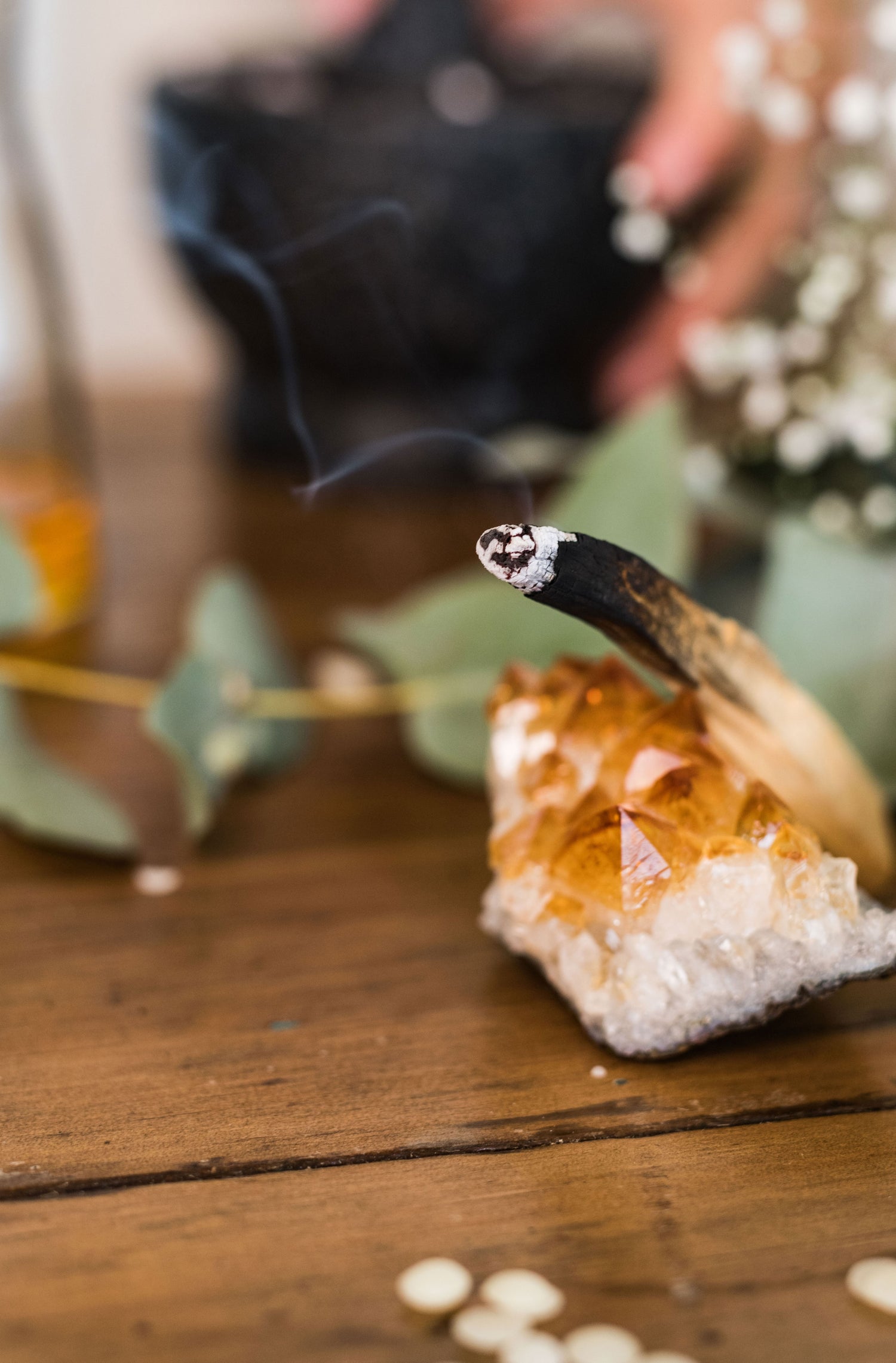Burning palo santo wood against a crystal
